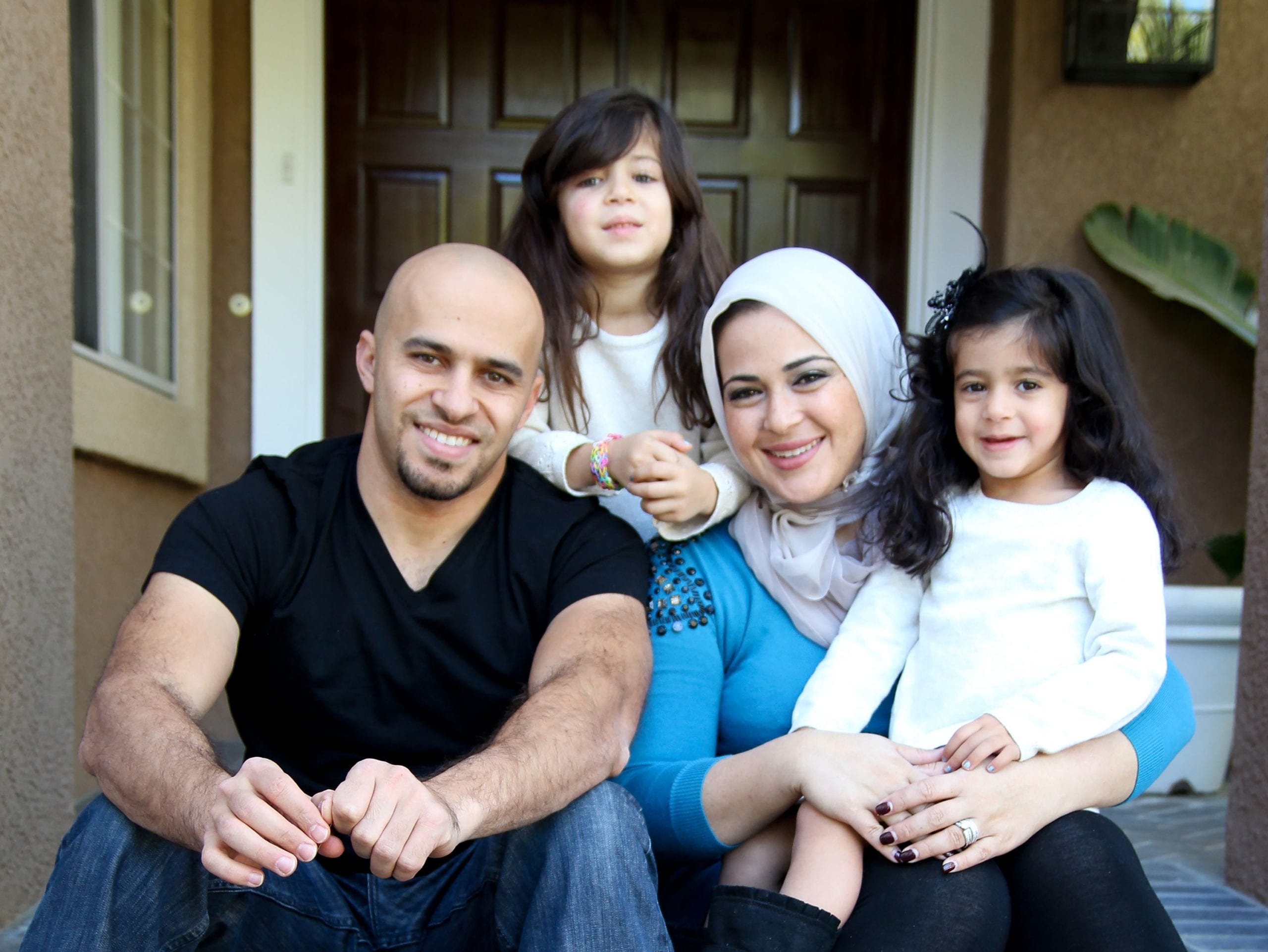 family in front of new home