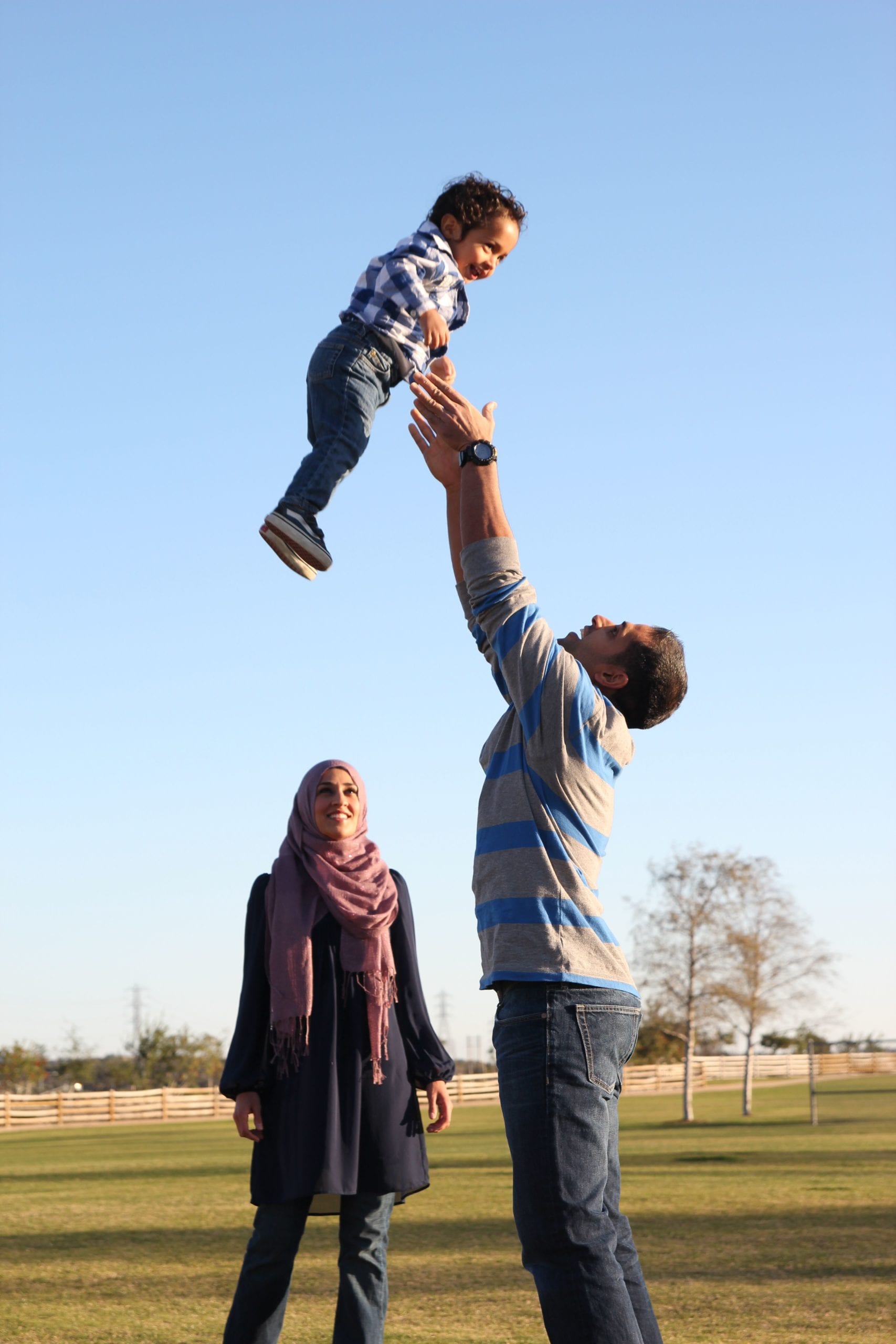 man throwing his child in the air