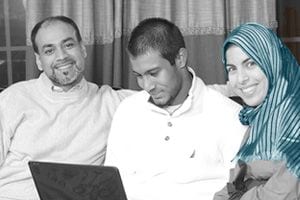 woman and man smiling on couch with man in between them