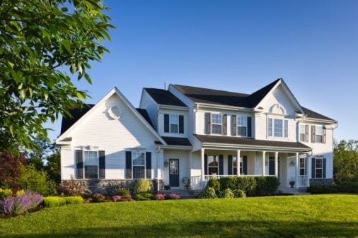 two story white house with lawn