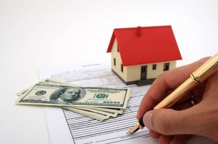 person filling out house financial documents