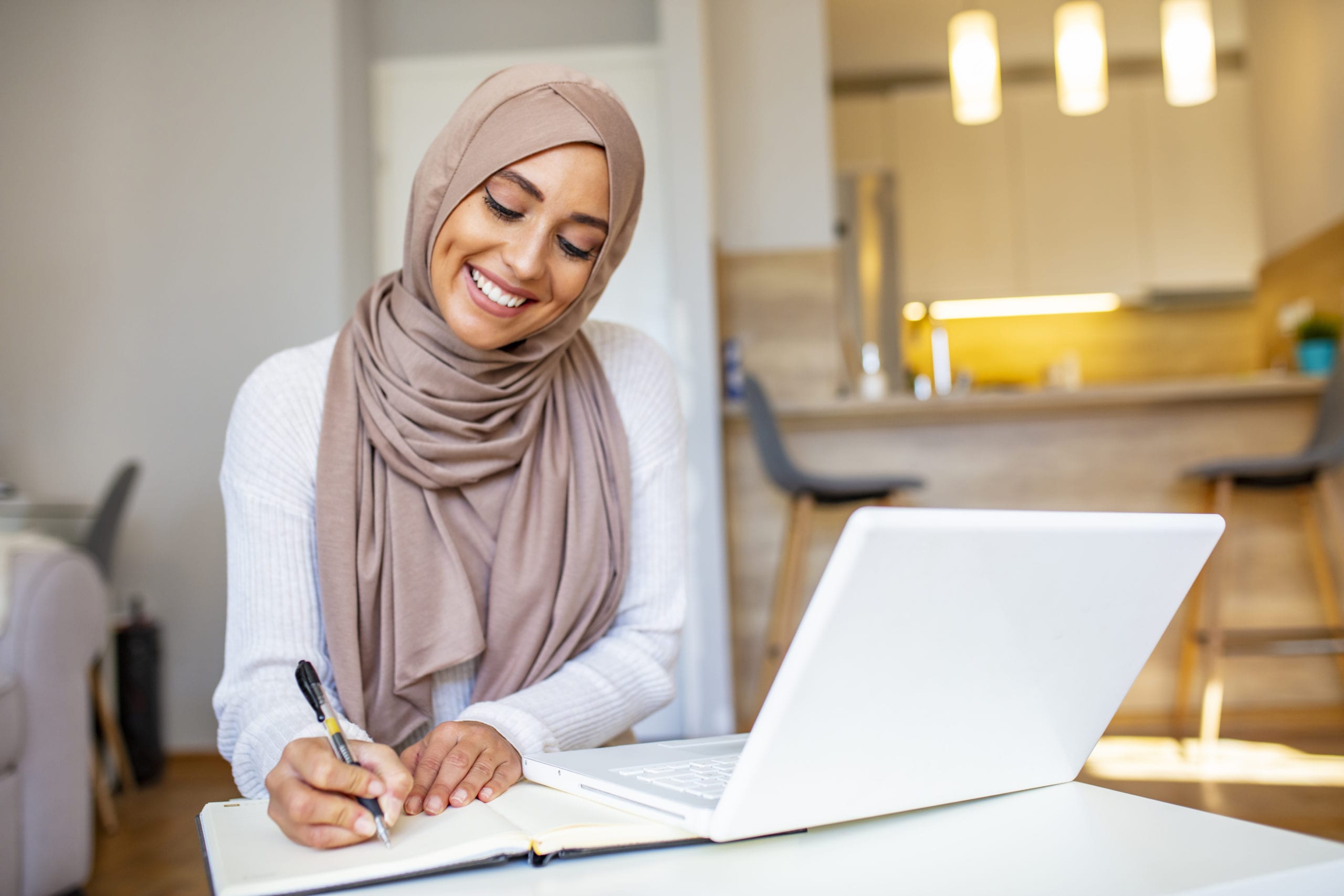 woman smiling writing on notepad