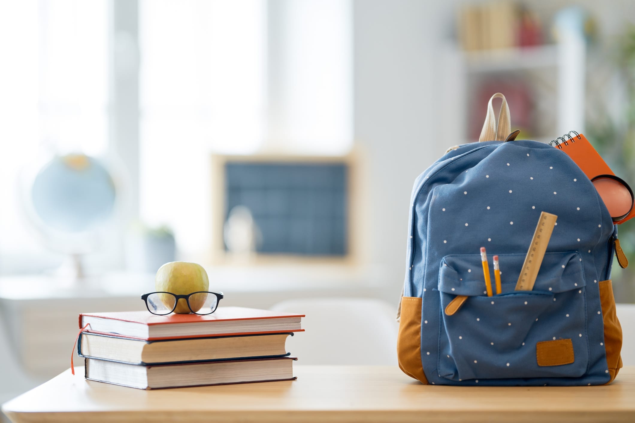 stack of books next to backpack