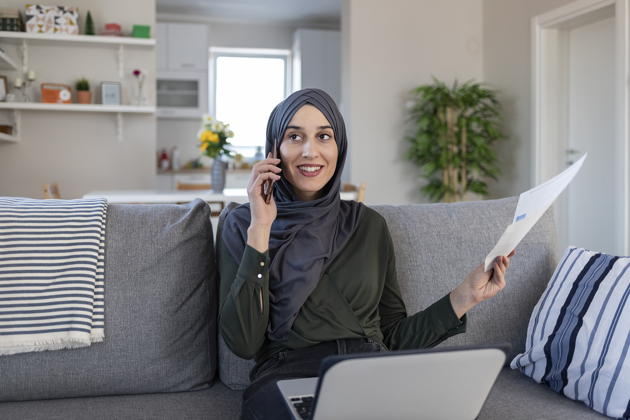 woman on the phone holding paper